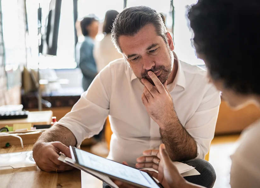A man contemplating with his hand over his mouth